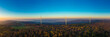 Aerial panorama of wind farm in forested Schurwald range at dusk