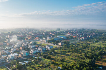 village from a height, blue sky and small private houses, Poland