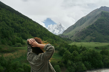 Wall Mural - Woman outdoors in the mountains travel landscape nature