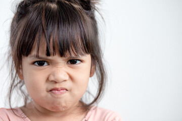 angry little girl over white background, sign and gesture concept