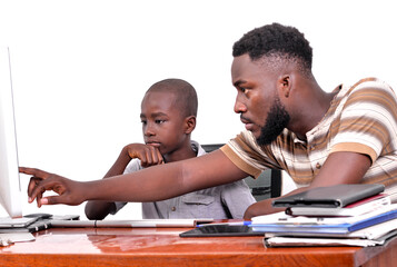 Wall Mural - young father teaches his little boy to use a laptop.