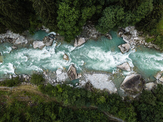 Aerial top view of a splendid whitewater on a mountain river in Swiss Alps