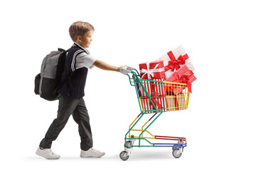 Poster - Full length profile shot of a schoolboy pushing a mini shopping cart full of wrapped presents