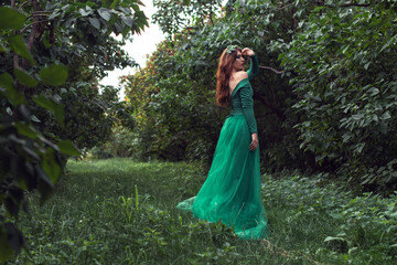  Young woman in green dress in the park