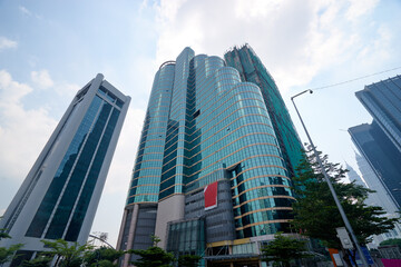 Wall Mural - Modern city architecture. Skyscrapper against sunny sky.