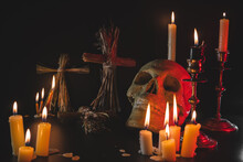 Old Skull And Candle With Incense On Old Altar Plate Which Has Dim Light. Select Focus, Black Background. Straw Voodoo Dolls.