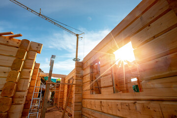 Poster - New house wooden log construction interior with exposed framing roof with sun light