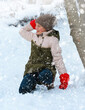 © soleg - a girl plays snowballs outside, beautiful winter weather and white snow around