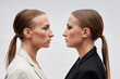 © VISTA by Westend61 - Twin sisters looking at each other by white background