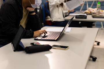 group young Asia lady student work on assignment, course work, worksheet, finance graph account chart using computer, calculator, phone market plan on desk in classroom or office