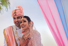 Indian Bride And Groom In Traditional Wedding Dress Smiling Together