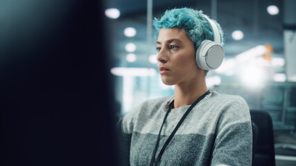 Poster - In Diverse Office: Portrait of Young Stylish Woman Working on Desktop Computer. Focused Motivated Girl Creating Modern Content, Colorful Project Design. Uses Headphones to Listen to Podcast, Music