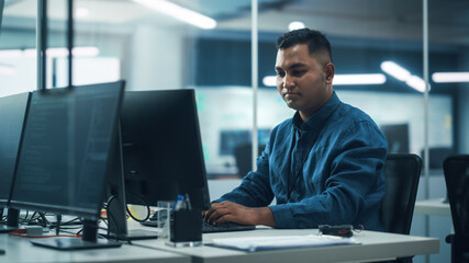 Poster - In Diverse Office: Portrait of Handsome Indian Man Working on Desktop Computer. Professional Programmer Creates Innovative Software, Modern App Design. Stylish Multi-Ethnic Authentic Workplace