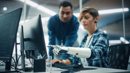 Aufkleber - Teamwork In Diverse Office: Smiling Project Manager Talks with Happy Woman with Disability with Prosthetic Arm to Work on Desktop Computer. Professionals Create e-Commerce Software App Solution