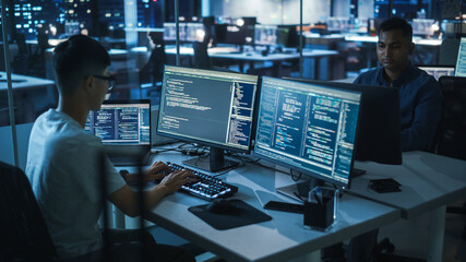 Poster - Night Office: Young Japanese Man in Working on Desktop Computer. Diverse Multi-Ethnic Team of Programmers Typing Code, Creating Modern Software, e-Commerce App Design, e-Business Programming.