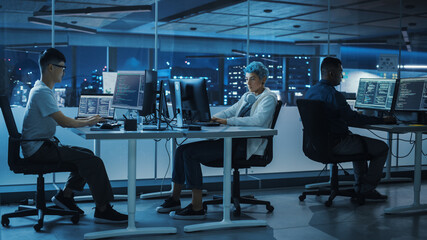 Poster - Diverse Office at Night: Multi-Ethnic Team of Young Programmers Working on Desktop Computers, Screens Show Coding Language User Interface. Software Engineers Create Innovative e-Commerce App.
