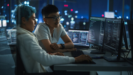 Poster - Teamwork In Diverse Office at Night: Project Manager Talks with Creative Solutions Specialist, They Discuss App Code Computer. Stylish Professionals Programming, Create e-Commerce Software