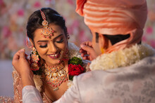 Indian Groom Tying Mangal Sutra Around Bride Neck Wedding Ceremony
