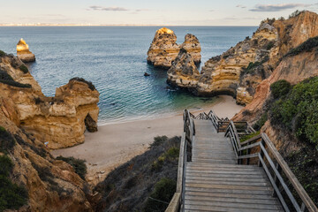 Wall Mural - Wooden staircase leading towards Praia do Camilo (Algarve, Portugal)