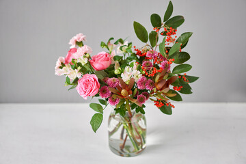 Finished flower arrangement in a vase for home. Flowers bunch, set for interior. Fresh cut flowers for decoration home. European floral shop. Delivery fresh cut flower.