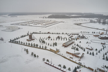 Wall Mural - Scenic aerial view of small wooden village complex in ancient russian town Bolgar in Tatarstan republic in Russian Federation. Beautiful winter look of small settlement in wooden architecture style