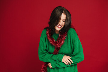 Wall Mural - White woman laughing while posing with Christmas tinsel garland