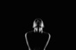 © eugenepartyzan - Nude Woman silhouette under light in the dark