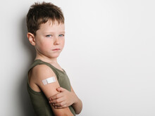 Schoolboy After Vaccination With Band Aid On Arm