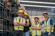 © Thirawatana - Group of technicians or foreman. Team of workers and engineer in parts warehouse. Space for Text.