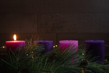 Single Candle Lit On Advent Wreath For First Week Of Advent With Pillar Candles, Wood Background And Copy Space