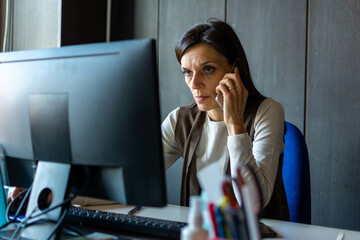 Wall Mural - Beautiful Businesswoman have phone conversation in office.