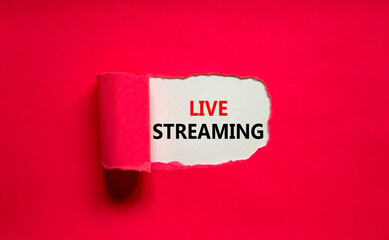 Live streaming symbol. Concept words Live streaming appearing behind torn pink paper. Beautiful pink background. Business, live streaming concept, copy space.