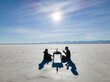 © Cavan Images - Two friends having a meal in the desert