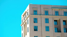 Modern Neoclassical Building With Intense Blue Sky Reflectedin Windows And Negative Space For Copy