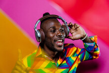 Smiling Man Listening Music Against Colored Background