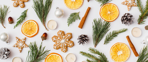 Christmas Banner. winter, new year composition. Christmas frame made of Fir tree branches, cinnamon sticks, candies, gingerbread on white background. Flat lay, top view