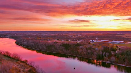 Wall Mural - Perfect slow panning view of tranquil water reflecting sunrise with red clouds and colorful sky. This scenic yet generic view makes an excellent background for text or graphics too.