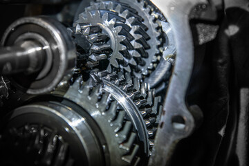 car transmission, gearbox with visible gears and cogs in the garage.