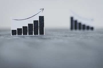 financial markets or money and investments, charts showing upward and downward trends next to each other with only one of them in focus