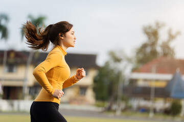 Wall Mural - woman running in the park in early morning