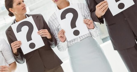 Wall Mural - Confused group of caucasian businessmen and businesswomen holding question mark signs