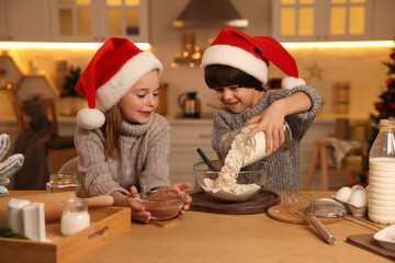 Wall Mural - Cute little children making dough for Christmas cookies in kitchen