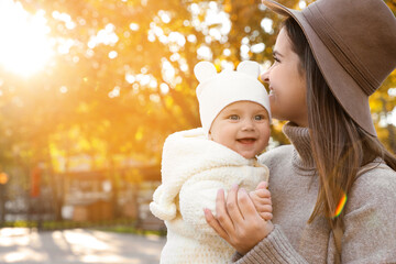 Canvas Print - Happy mother with her baby daughter outdoors on autumn day, space for text