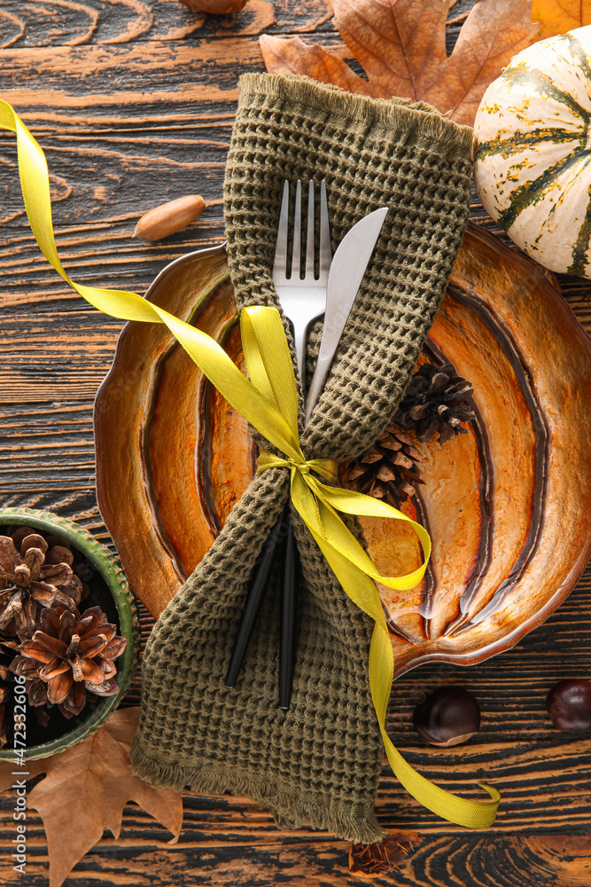 Composition with table setting and autumn decor on wooden background