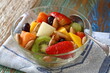fruit salad with baru nuts and honey in a bowl