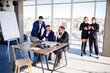 © DSMT - Business people working together in a modern office with cityscape view. The director tells the staff about new technologies. Office work concept