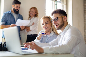 Portrait of creative business people team working together and smiling in office.