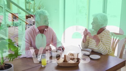 Canvas Print - Animation of vibes text in red and white over happy caucasian senior couple having breakfast at home