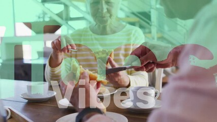 Canvas Print - Animation of vibes text in red and white over happy caucasian senior couple having breakfast at home