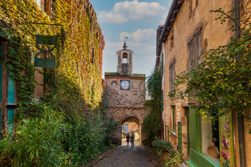 Wall Mural - Street with its clock gate in the medieval village of Cordes sur Ciel, in Tarn, Occitanie, France